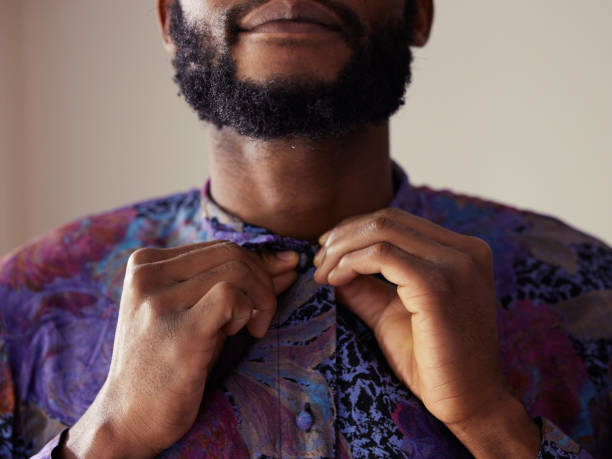 Shot of an unrecognizable man buttoning a shirt at home When you look good, you feel good buttoning stock pictures, royalty-free photos & images