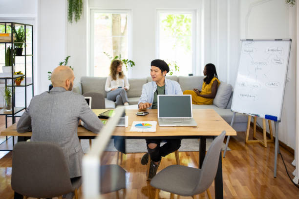istock Business colleagues talking in modern workplace 1326279863