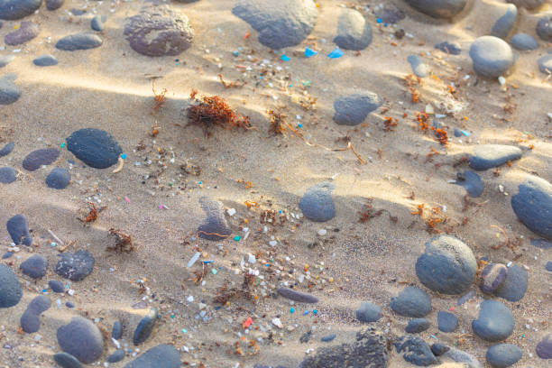 Microplastics in the sand stock photo
