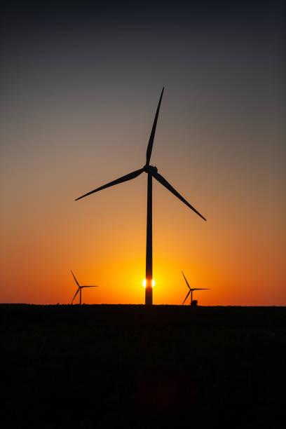 istock Wind turbines and field at sunrise Eco environment 1326283324