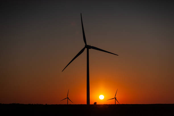 istock Wind turbines and field at sunrise Eco environment 1326283518