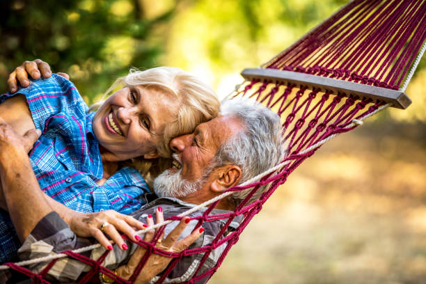 istock Romantic couple relaxing in tropical hammock at sunset 1326287769