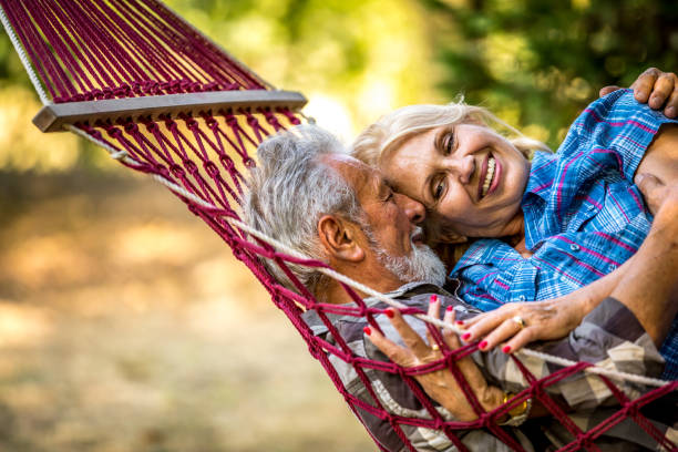 istock Romantic couple relaxing in tropical hammock at sunset 1326287784