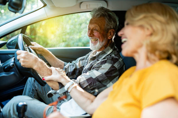 istock Cheerful senior couple driving car 1326288318