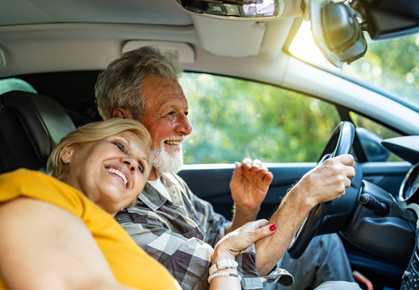 istock Cheerful senior couple driving car 1326288336