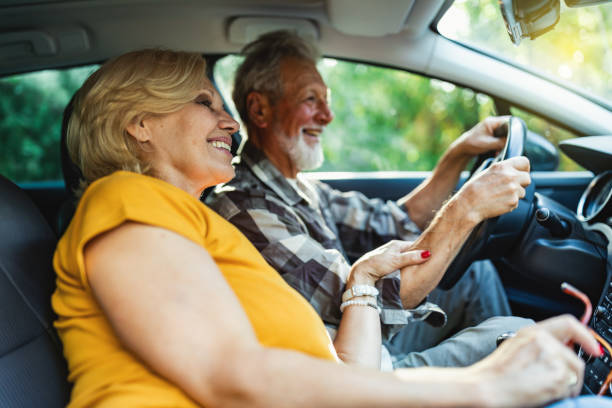 istock Cheerful senior couple driving car 1326288339