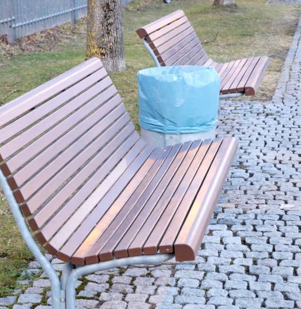 istock Wooden benches outdoors with waste bin 1326288940