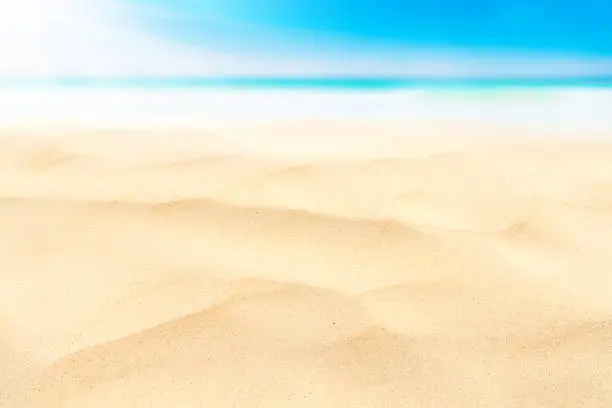 Copy space blur tropical beach with bokeh sun light wave on blue sky and white cloud abstract background. Summer vacation outdoor and travel holiday adventure concept. Vintage tone filter effect color.