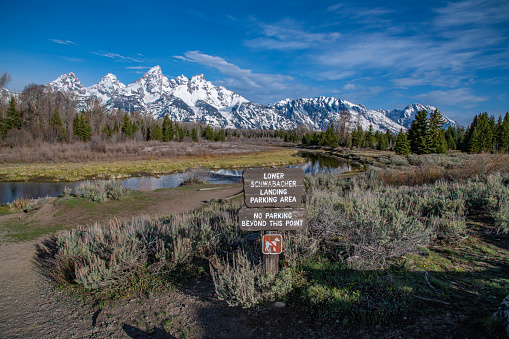 View of Teton range from Snake River with morning light reflections. This is at Schwabacher Landing on the Snake river near Moose village, Moran, Jackson Hole and Dubois, Wyoming in western USA. John Morrison - Photographer