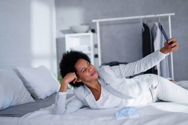 istock Young black business women just arrived at the hotel taking a rest from a trip, using a smart phone 1326290787