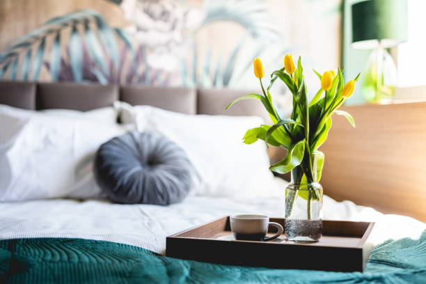 istock Coffee and flowers on bed tray in elegant bedroom 1326292503