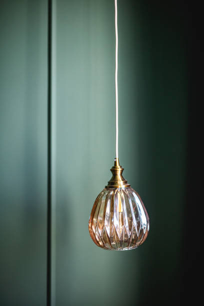 istock Elegant retro lamp hanging against dark green wall 1326292509