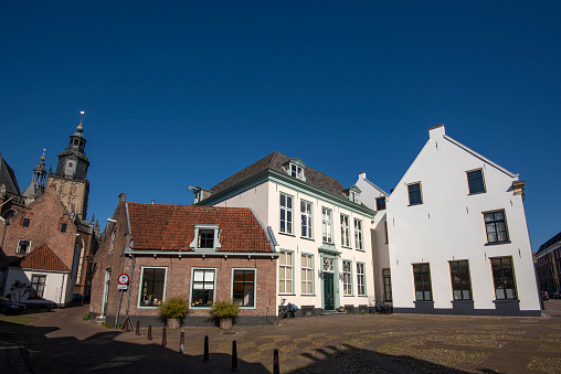 Cobblestone square in the medieval city center of Zutphen, with a small street leading to the Walburgis Church on the left.