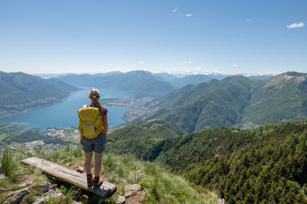 istock Hiker female contemplates view from mountain top 1326294446
