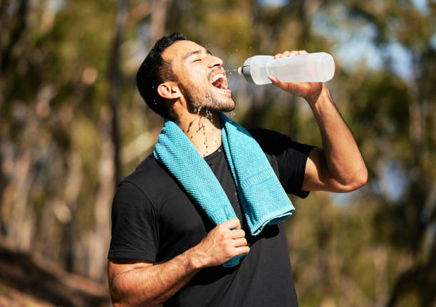 istock Shot of a man drinking water while out of a run 1326294720