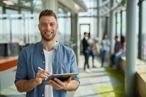 istock A successful male web designer using digital tablet in the office hallway 1326295317