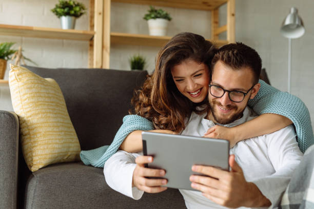 istock Young happy couple using digital tablet at home 1326295749