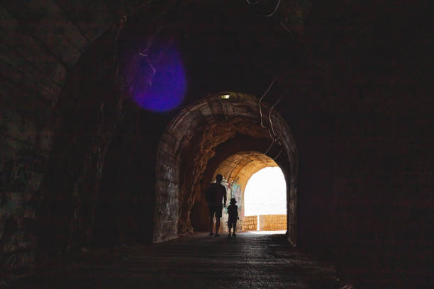 istock Tunnel cut out in the cliffs on the walking path 1326297005