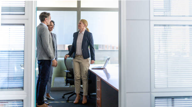 istock Female executive greeting business partners in her office 1326297240