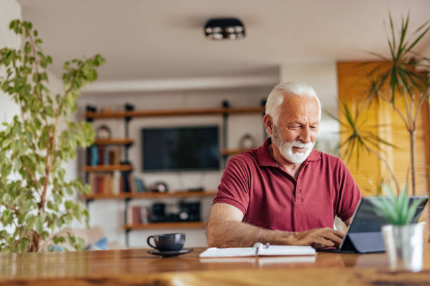 istock Senior man, working on his book, while drinking his coffee. 1326300546