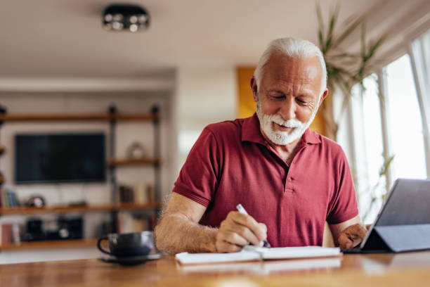 Senior man, writing a lovely message.
