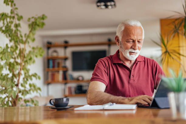 istock Senior man, enjoying his drink, during work hours. 1326300556