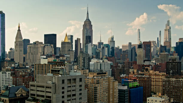 istock Drone Shot of Manhattan Skyline with Puffy Clouds 1326302152