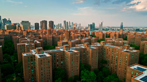 Aerial view Over Stuytown and East River Towards Long Island City Aerial establishing shot of Stuyvesant Town-Peter Cooper Village on the east side of Manhattan on a sunny evening in summer. queens new york city stock pictures, royalty-free photos & images