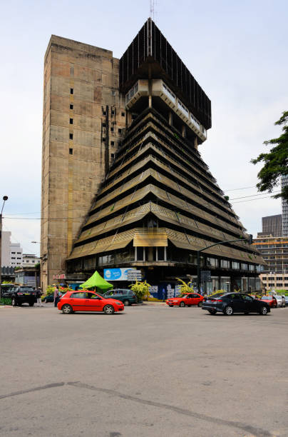 La Pyramide building - corner of Boulevard Botreau Roussel and Avenue Franchet d'Esperey, Abidjan, Ivory Coast Abidjan, Ivory Coast / Côte d'Ivoire: La Pyramide shopping mall, completed in 1973, architecture by Rinaldo Olivieri, modernism, designed to fit the climate and reflecting the local vernacular architecture - the cascading facade of this brutalist masterpiece is one of the symbols of Abidjan - built during the Ivorian 'miracle' period - state owned, managed by the government real estate company, the SOGEPIE - located in the financial district, the Plateau. abidjan skyline stock pictures, royalty-free photos & images