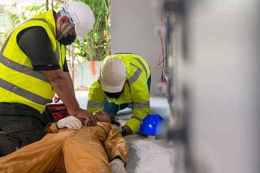 Safety team CPR for first aid electrician worker accident electric shock unconscious. Asian electrician worker accident electric shock unconscious in site work.