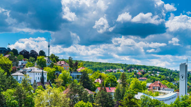 Germany, Stuttgart city houses, church and television tower forming the skyline of this magical city inside green nature landscape on sunny day stock photo