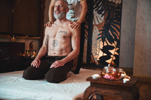 homme barbu heureux profitant de la thérapie manuelle asiatique - tattoo japanese culture women asian ethnicity photos et images de collection