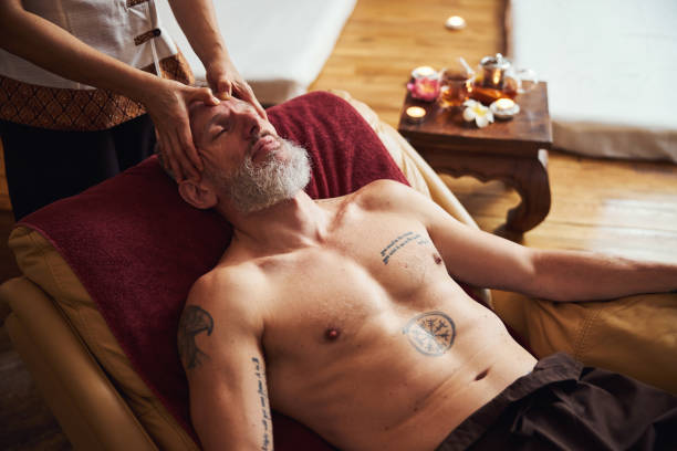istock Serene bearded man relaxing in thai spa 1326305075