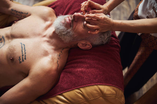 istock Handsome grizzled man during asian face massage 1326305284