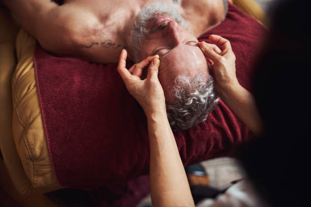 istock Grizzled guy relaxing during asian face massage 1326305286