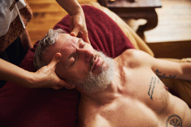 istock Calm grizzled man relaxing during head massage 1326305298
