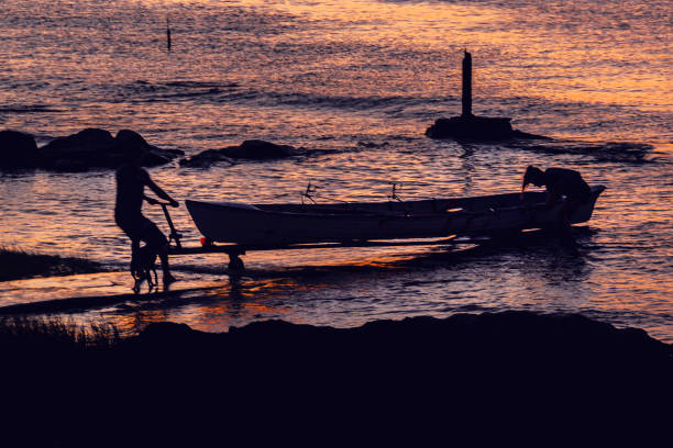 People carrying a boat to shore at montevideo coast, uruguay