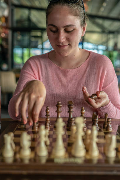 istock Women playing chess at cafe 1326311962