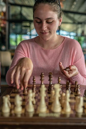 Women playing chess at cafe