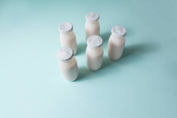 istock Bottles with probiotics and prebiotics dairy drink on light blue background. 1326314298