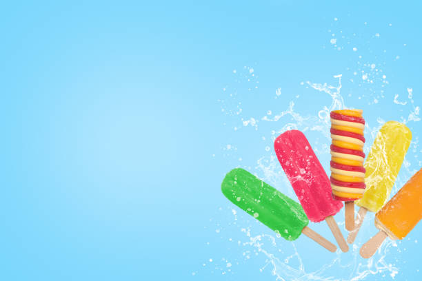 istock Colorful popsicles ice cream splash on blue background with copy space. 1326319015