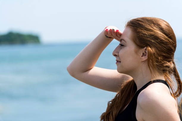 istock Redhead woman on the beach 1326319392