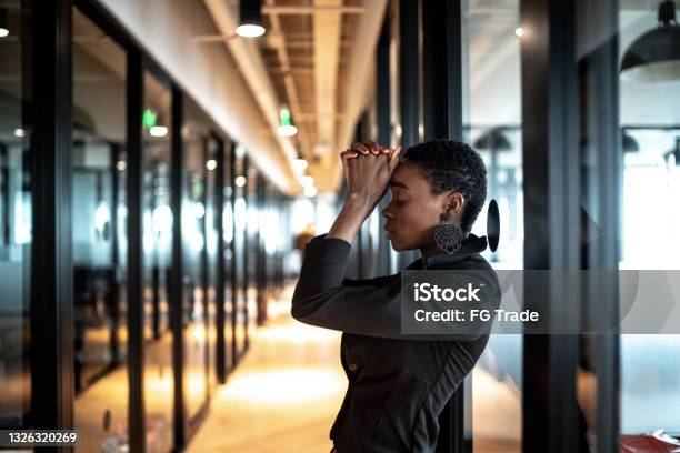 Worried Young Business Woman At Corridor Office Stock Photo - Download Image Now - Emotional Stress, Working, Anxiety