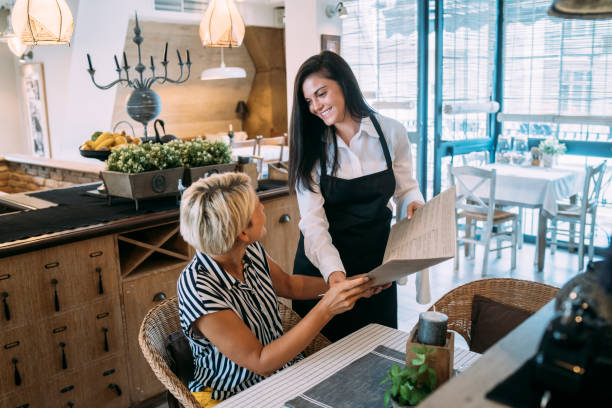 Waitress helping a customer to choose a dinner