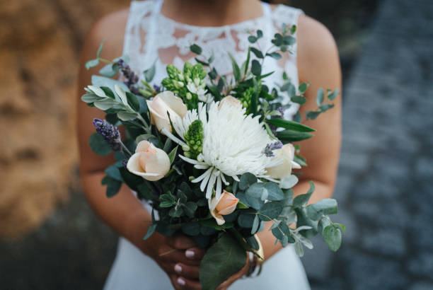 istock Bride holding flower bouquet relaxes on rocky coastline 1326322505