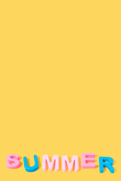 istock Word Summer in colors on yellow background. copy space. 1326322815