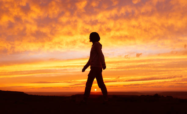 istock Woman silhouette at sunset. 1326322839