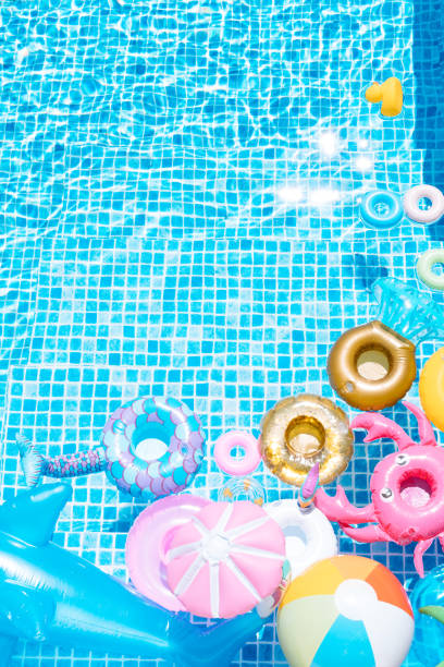 istock various inflatable on a pool water background. ball, crab, dolphin, float. summer and travel concept. copy space 1326322848