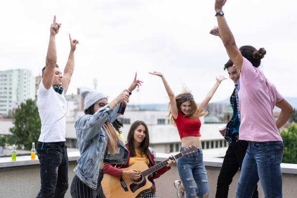 istock Friends having fun, singing songs on a rooftop 1326323022