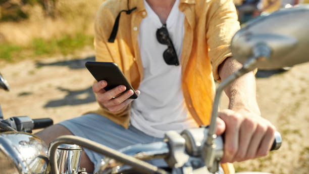 istock Smartphone in hands of young caucasian man on scooter 1326323913